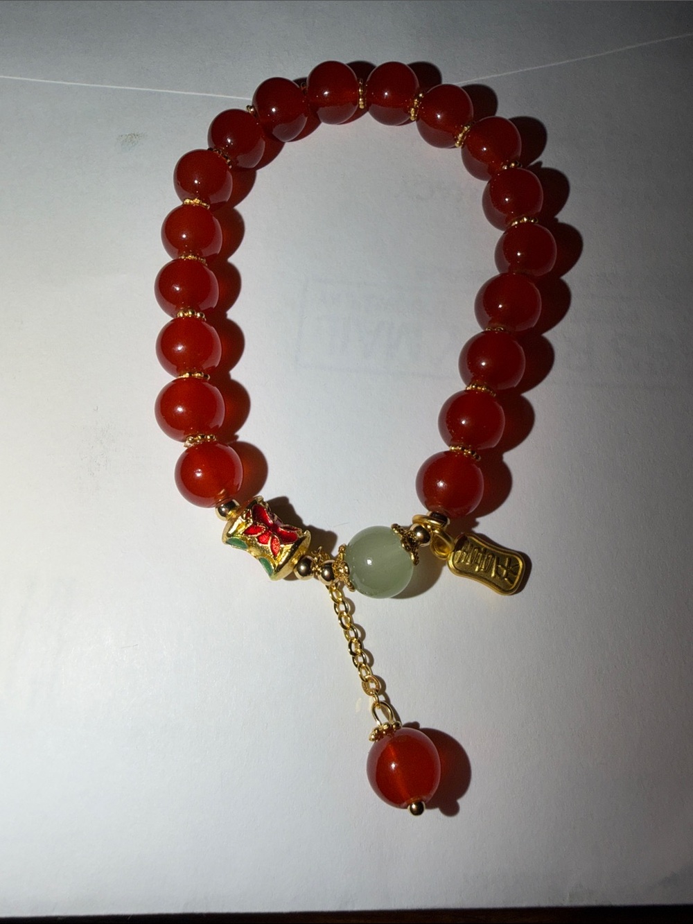Women's Red Beaded Bracelet with Gold Accents and Green Focal Bead
